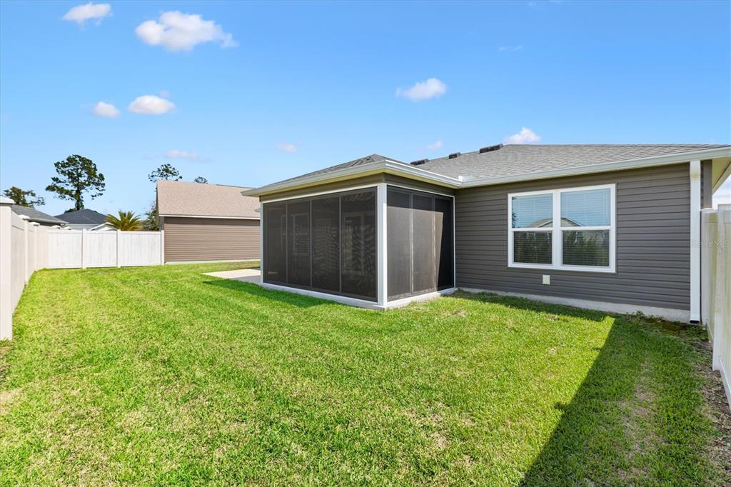 6767 Mary Loop The Villages, FL 34762 - Photo 25 of 26 a view of a backyard with a garden and plants