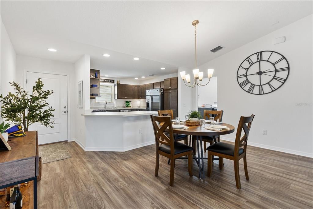 6767 Mary Loop The Villages, FL 34762 - Photo 4 of 26 a view of a dining room with furniture window and wooden floor
