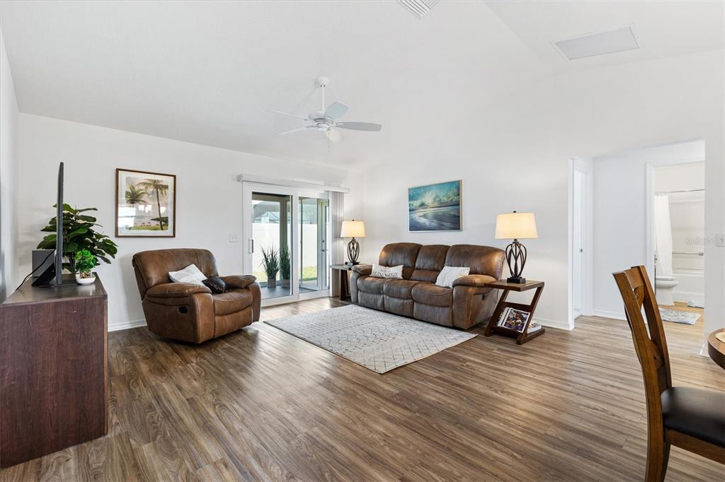 6767 Mary Loop The Villages, FL 34762 - Photo 8 of 26 a living room with furniture and a wooden floor