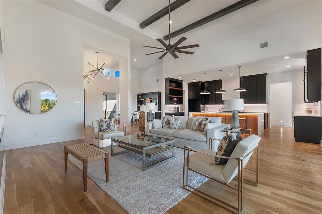 430 Whispering Way Red Oak, TX 75154 - Photo 14 of 40 Open-concept living space featuring wood-finish flooring, a high vaulted ceiling with exposed beams, and a modern ceiling fan