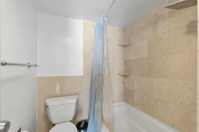 a bathroom with a toilet and shower