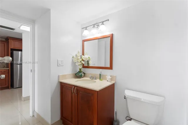 a bathroom with a sink toilet and mirror
