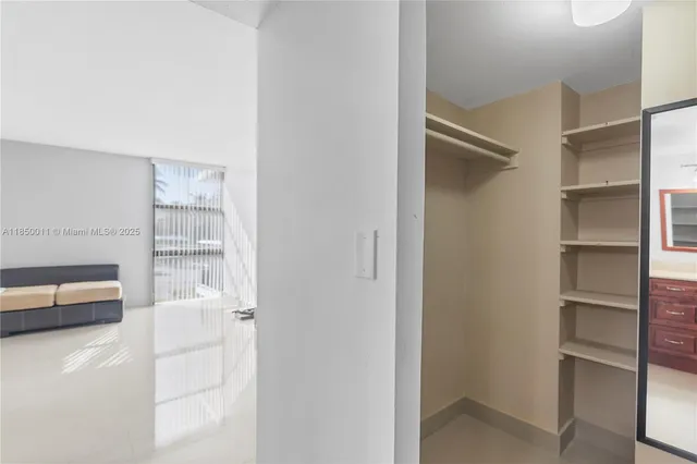 a room with a bed and a view of walk in closet