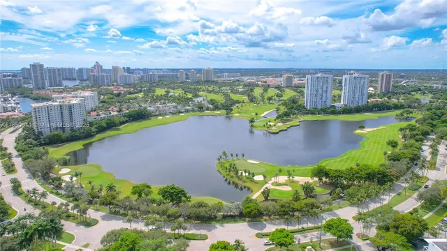 an aerial view of a house with a garden and lake view