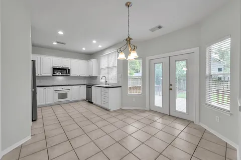 a kitchen with stainless steel appliances granite countertop a refrigerator and a sink