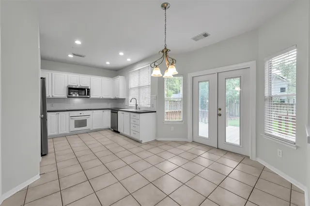 a kitchen with stainless steel appliances granite countertop a refrigerator and a sink