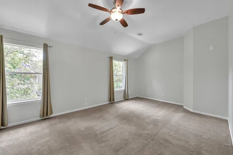 an empty room with closet and windows