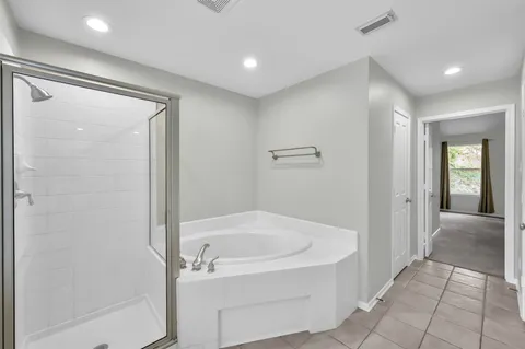 a bathroom with double vanity and a large mirror