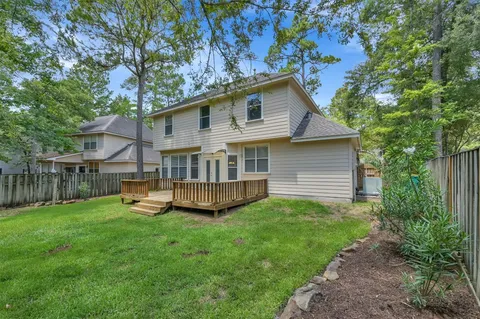 a view of a house with a yard and sitting area