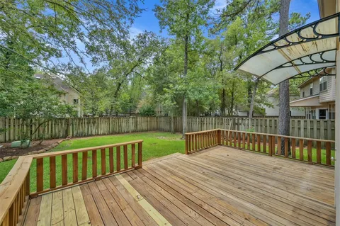 a view of balcony with wooden floor and fence