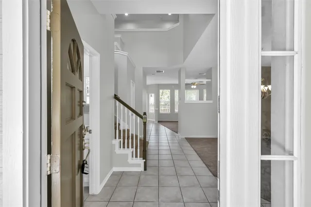 a view of a hallway with windows and stairs
