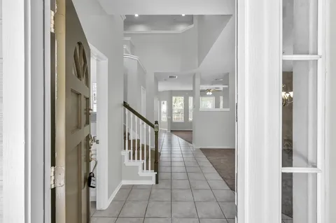 a view of a hallway with windows and stairs