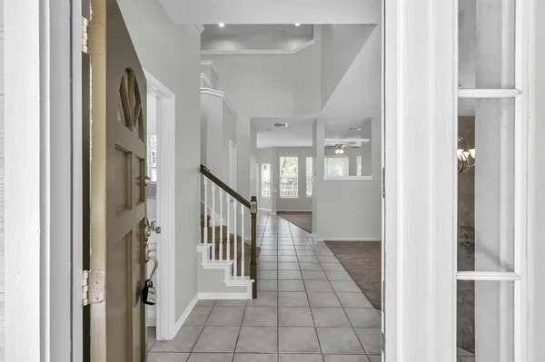 a view of a hallway with windows and stairs