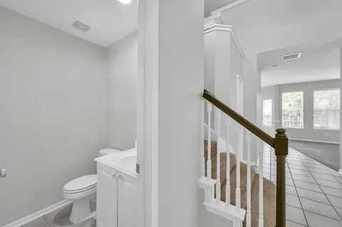 a bathroom with a toilet a sink and a shower