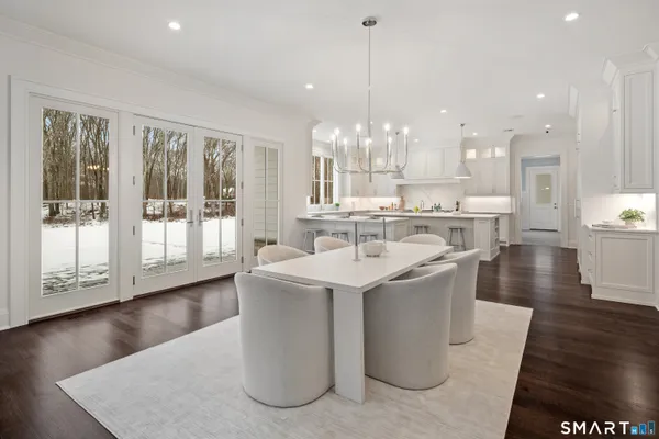 a kitchen with a sink and wooden floor