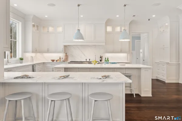a kitchen with stainless steel appliances granite countertop a sink a stove and a refrigerator