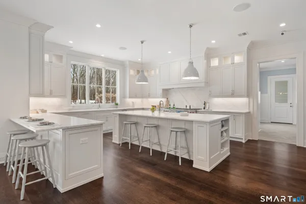 a kitchen with granite countertop a sink stove and cabinets