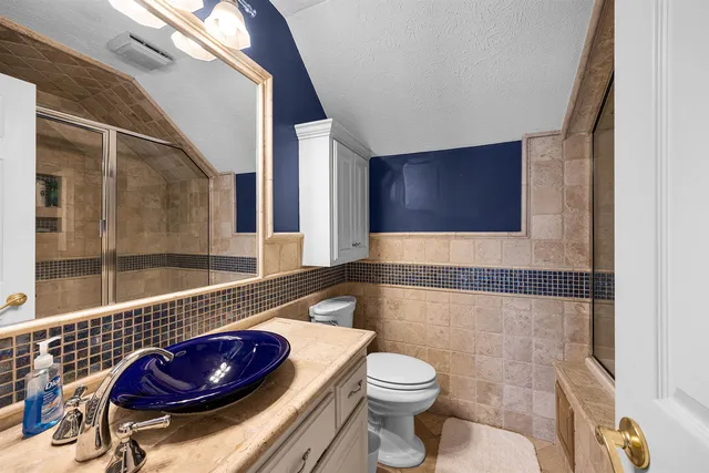 a bathroom with a toilet a sink and tub