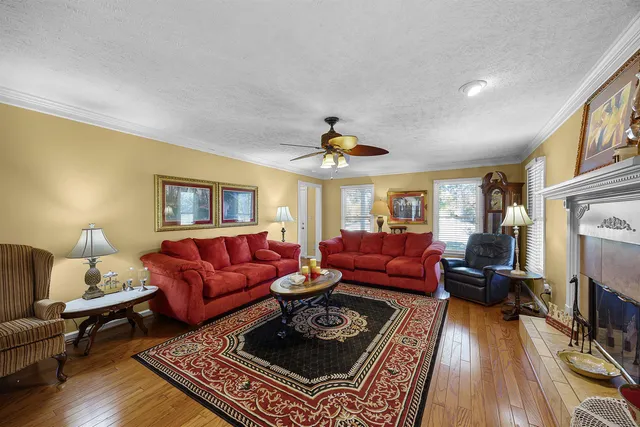 a living room with furniture a fireplace and a table