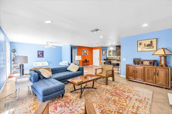 a living room with furniture and kitchen view