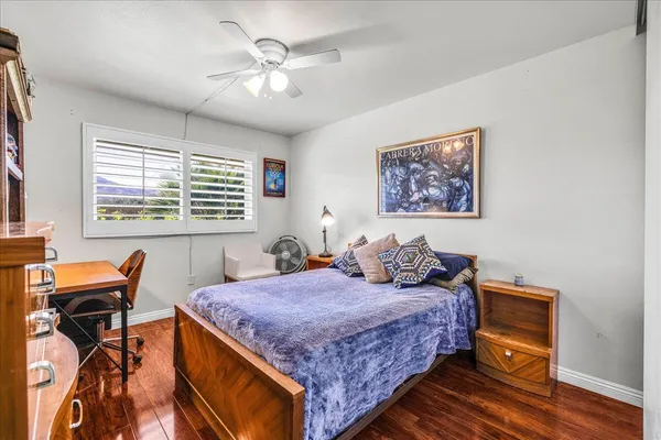 a bedroom with a bed and a table in it with chair
