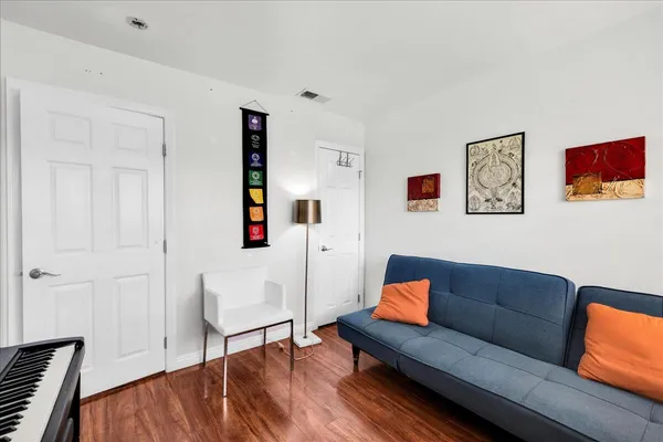a living room with furniture and wooden floor