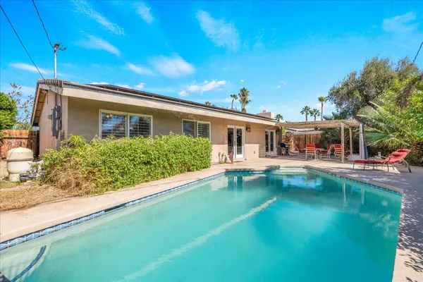 a view of house with swimming pool yard