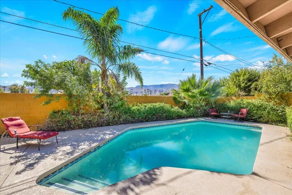 a view of a swimming pool with a yard