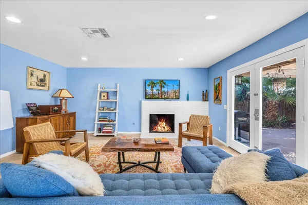 a living room with furniture and a fireplace