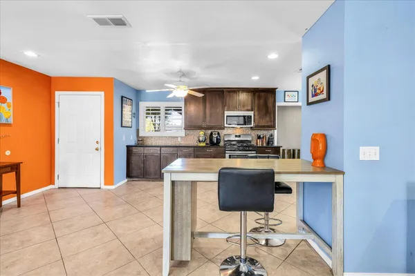 a kitchen with stainless steel appliances granite countertop a refrigerator and a stove top oven