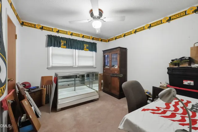 a bedroom with a bed couch and flat screen tv