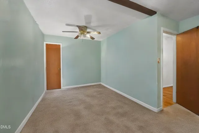 a view of a big room with wooden floor and stairs