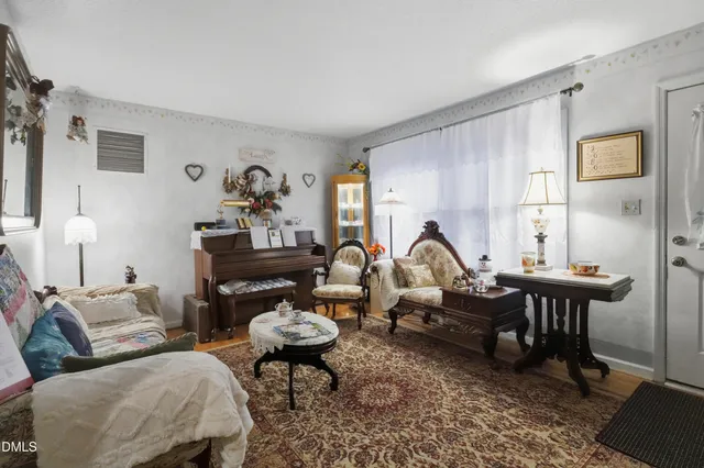 a living room with furniture a rug and a window
