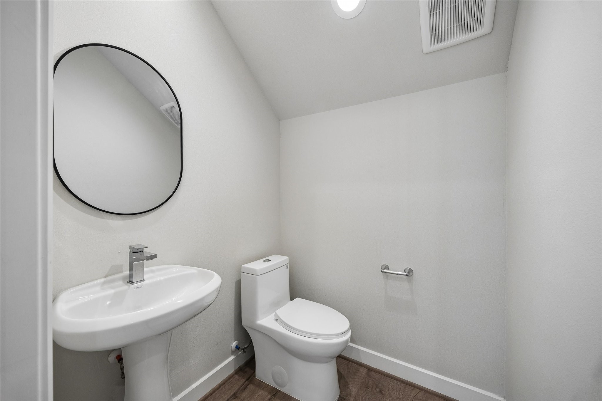 5914 Haring Lane Houston, TX 77091 - Photo 3 of 11 a bathroom with a toilet a sink and a mirror