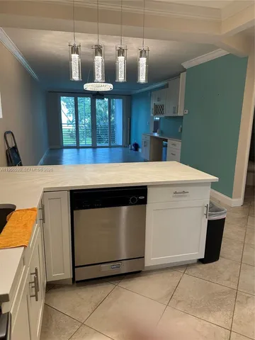 a kitchen with stainless steel appliances kitchen island a stove a sink and a refrigerator
