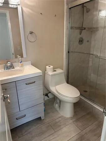 a bathroom with a toilet sink and a mirror