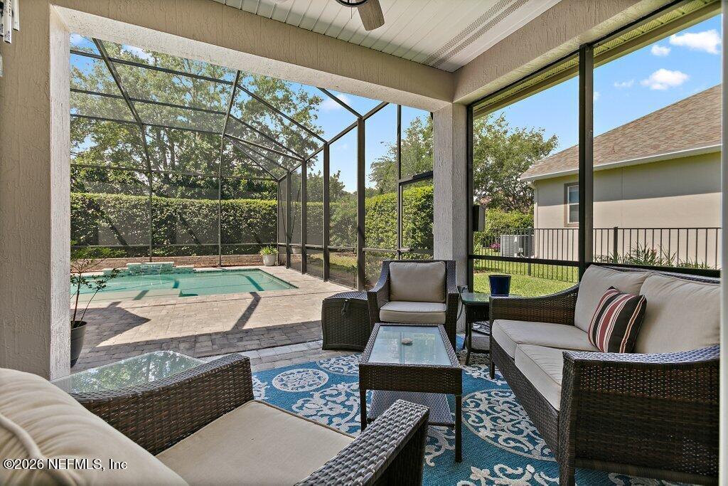 841 Ifield Road St. Augustine, FL 32095 - Photo 26 of 69 a living room with furniture and a floor to ceiling window