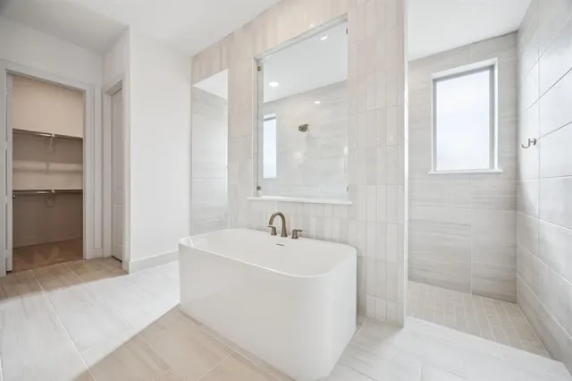 a spacious bathroom with a double vanity sink mirror and