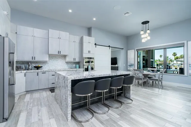 a kitchen with granite countertop cabinets stainless steel appliances and a counter space