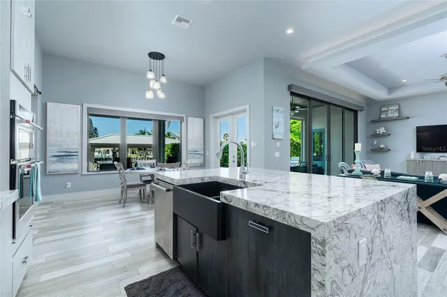 a kitchen with stainless steel appliances granite countertop a white cabinets and a refrigerator