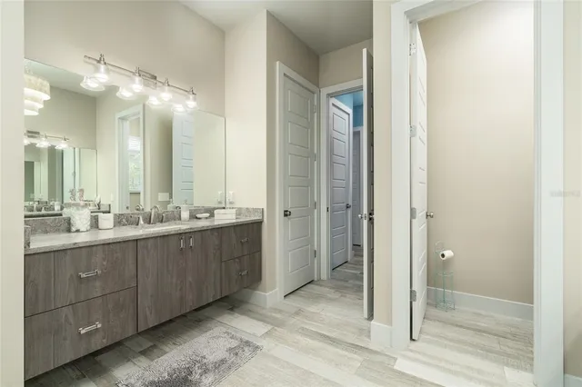 a room with gym equipment and wooden floor