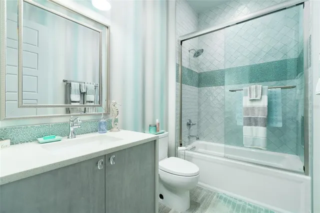 a bathroom with a double vanity sink toilet and shower
