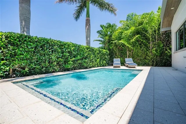 a view of a swimming pool with outdoor seating