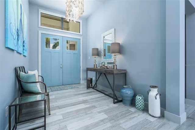 a living room with furniture a flat screen tv and a large window