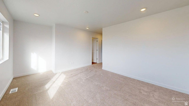 783 Pheasantbrook Drive, Unit 2A Centerville, UT 84014 - Photo 30 of 41 Spacious room featuring neutral carpeting, a large window, recessed lighting, and white walls