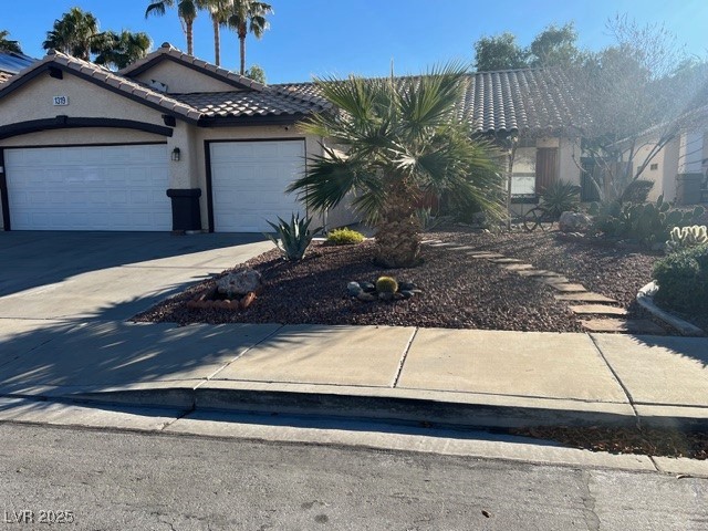 1319 Winter Solstice Avenue Henderson, NV 89014 - Photo 1 of 6 Single story home featuring stucco siding, concrete driveway, a garage, and a tiled roof