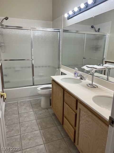 1319 Winter Solstice Avenue Henderson, NV 89014 - Photo 4 of 6 Full Guest bath featuring double vanity, enclosed tub / shower combo, and light tile patterned floors