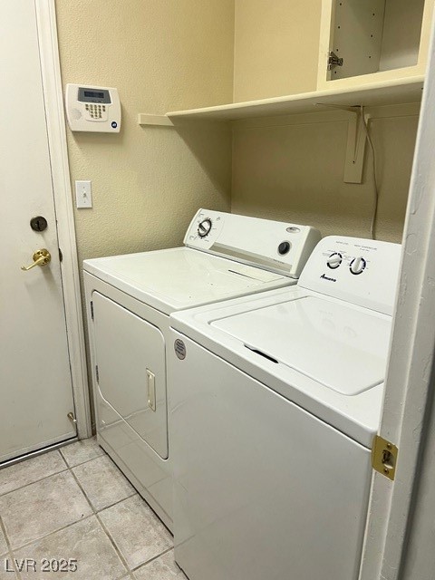 1319 Winter Solstice Avenue Henderson, NV 89014 - Photo 5 of 6 Laundry room with a textured wall, washer and dryer, and light tile patterned floors