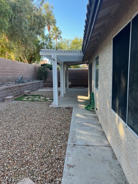 1319 Winter Solstice Avenue Henderson, NV 89014 - Photo 6 of 6 Fenced backyard featuring a patio and a pergola