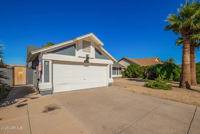 a view of a house with a yard and garage